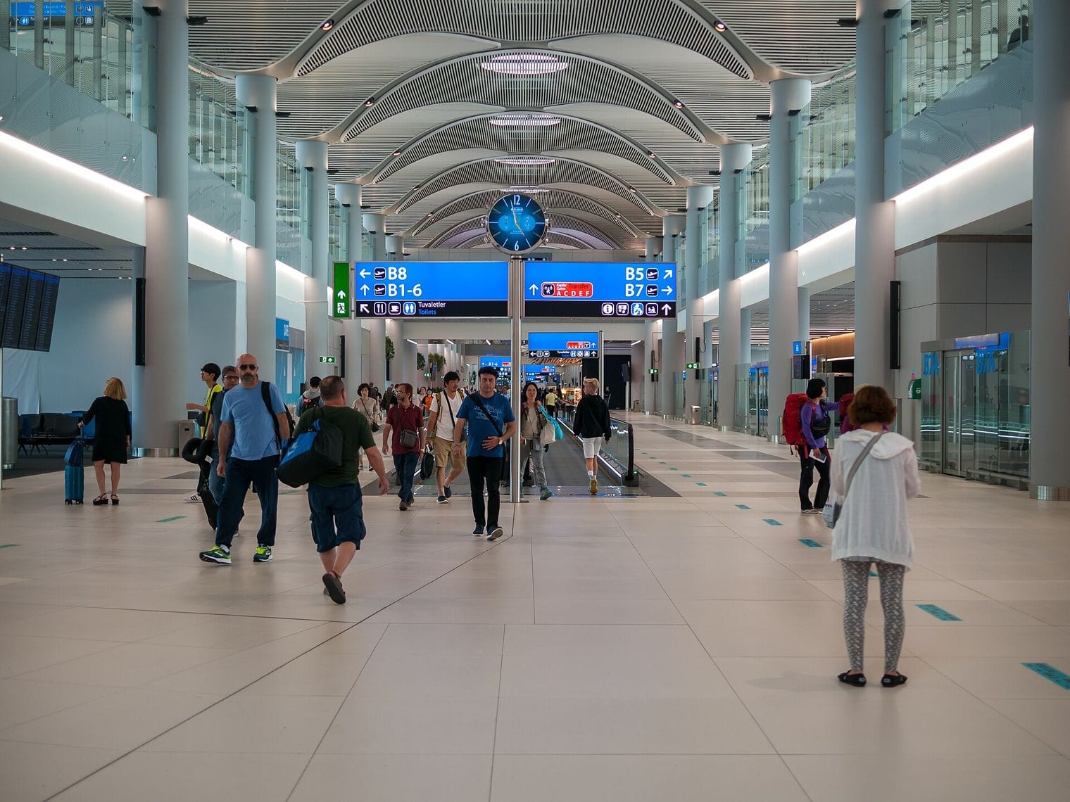 Travellers crossing the vaulted departures concourse inside the main terminal at Istanbul Airport