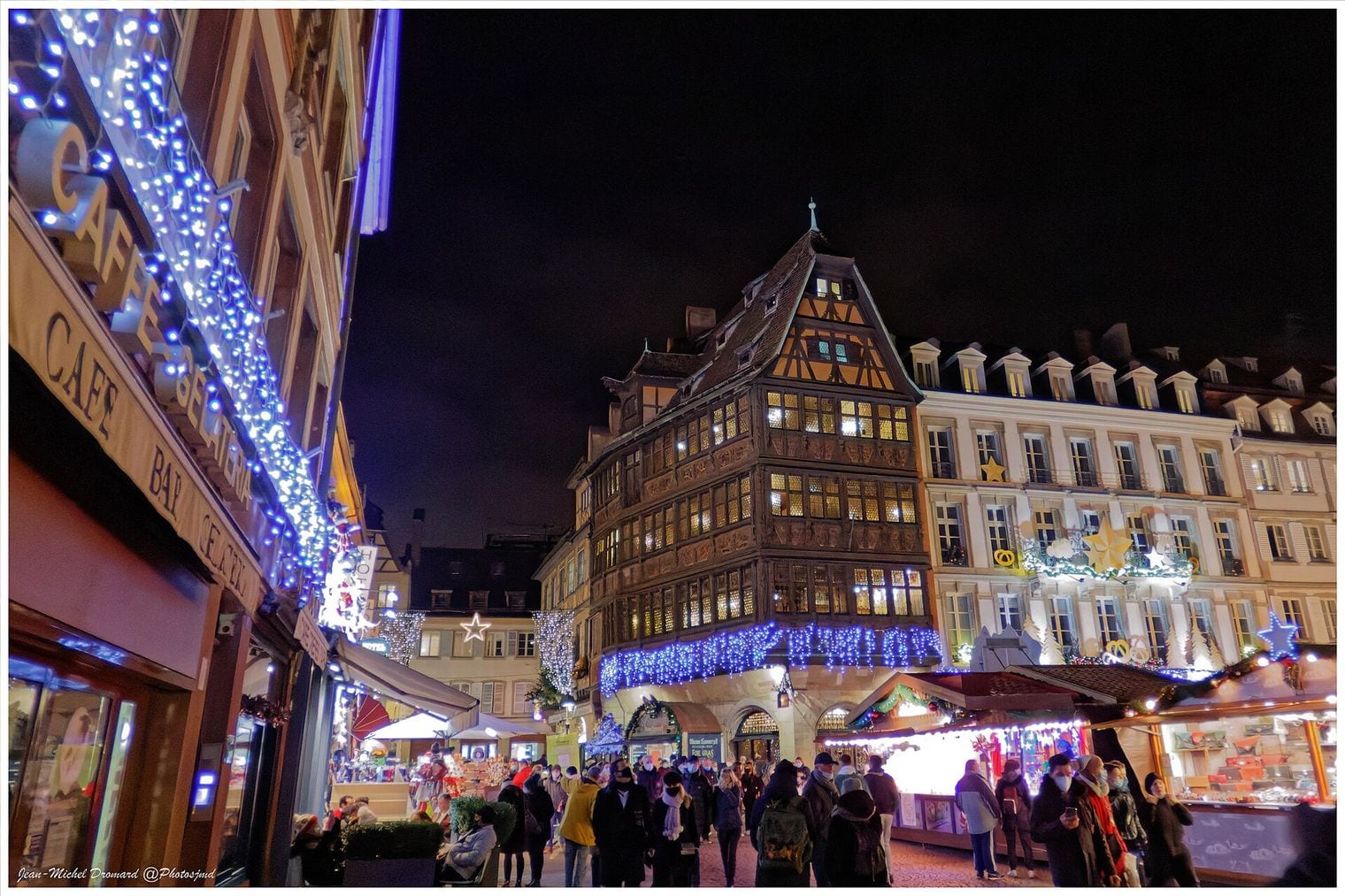 Kammerzell House and the stalls of the Strasbourg Christkindelsmärik lit up at night in Strasbourg, France