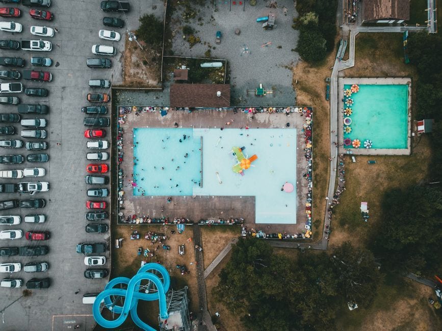Aerial view of a large water park pool, illustrative of a resort fun lagoon
