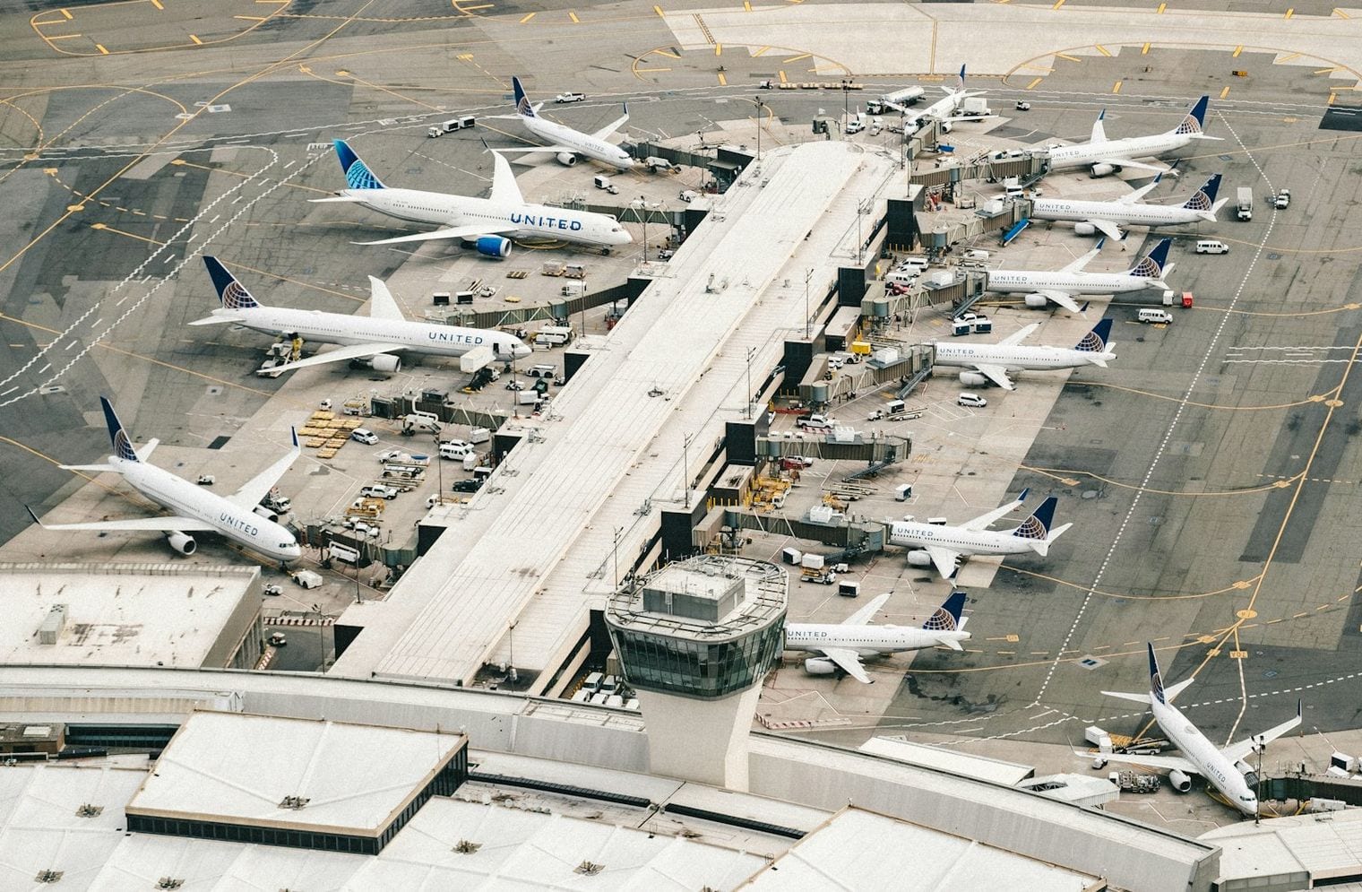 Satellite view of Hartsfield-Jackson Atlanta International Airport, showing five parallel runways and rows of aircraft parked along its concourses