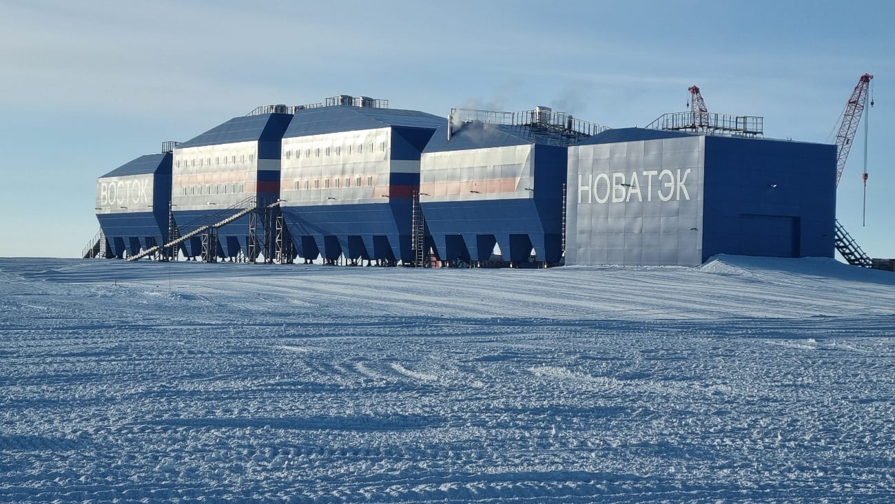 The blue modules of Vostok Station's new wintering complex on the flat ice sheet of the East Antarctic Plateau