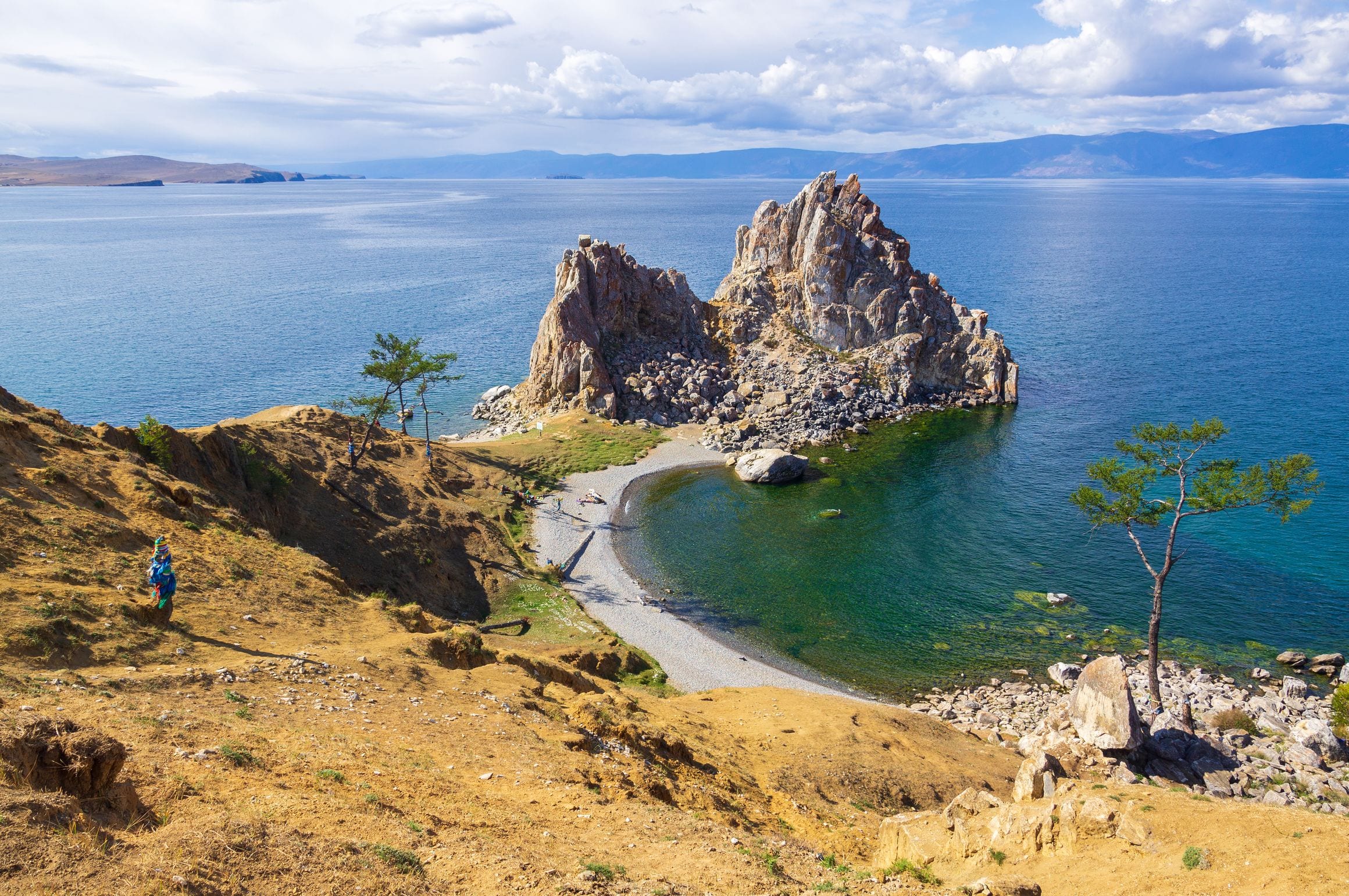 Shaman Rock at Cape Burhan on Olkhon Island rising from the clear blue open water of Lake Baikal in Siberia, Russia