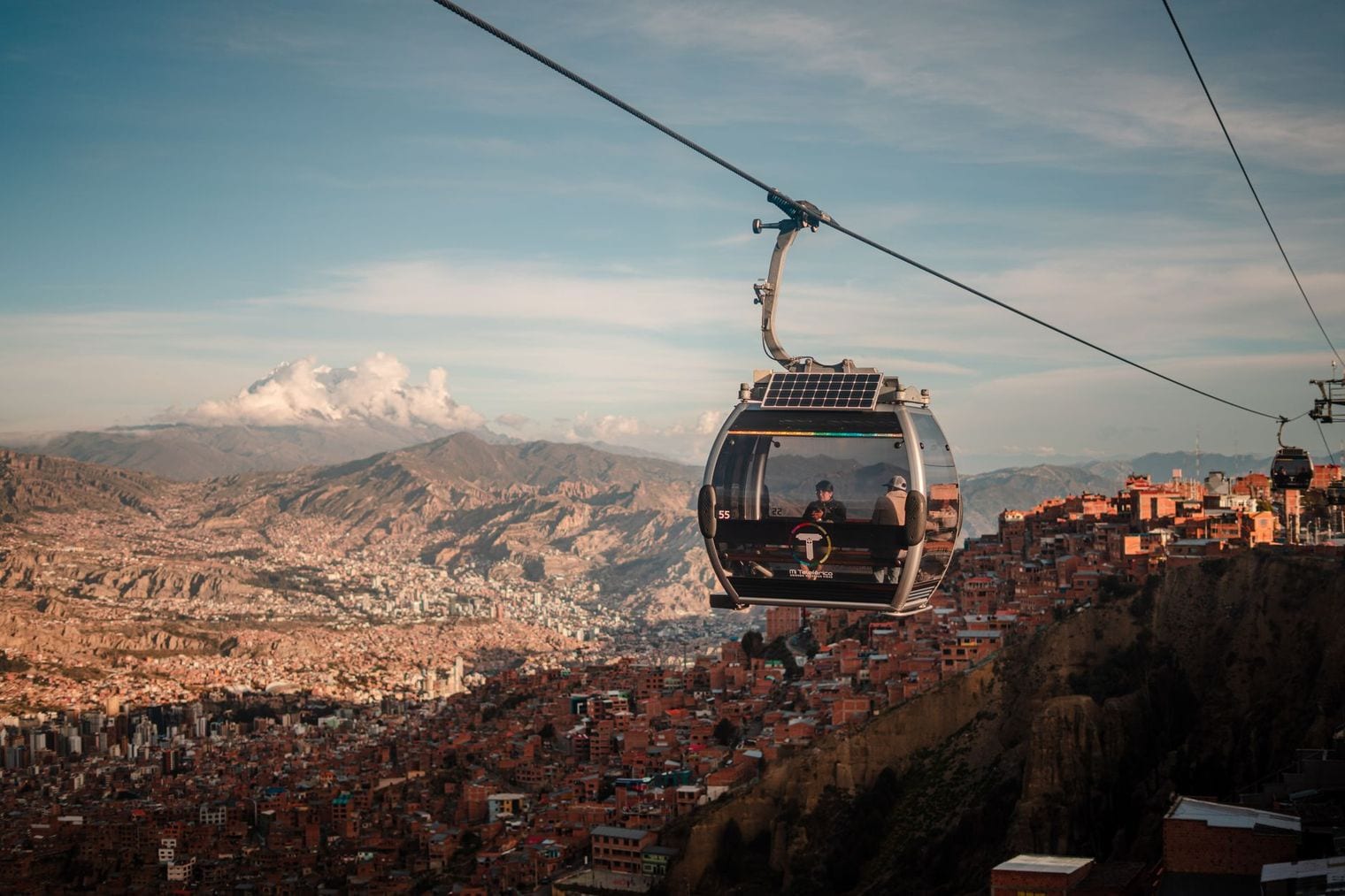 Aerial view over the dense high-rise neighbourhoods and stadium filling the canyon floor of La Paz, Bolivia