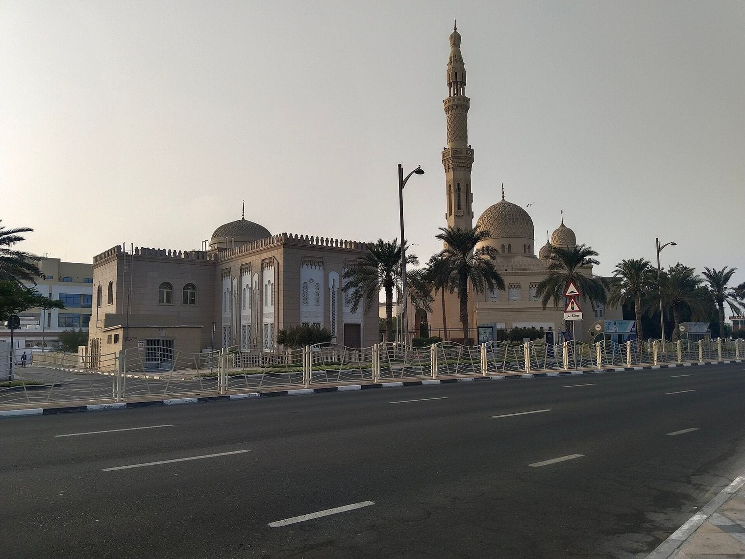 Jumeirah Mosque, with its minaret and domes, seen from the road outside in Dubai.