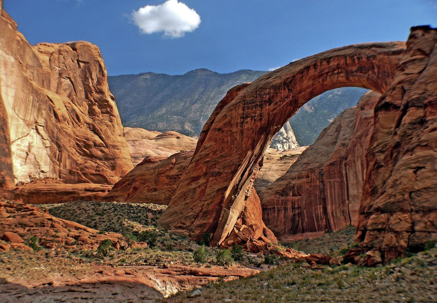 Rainbow Bridge, a symmetrical sandstone span arching over a desert canyon in Glen Canyon, southern Utah