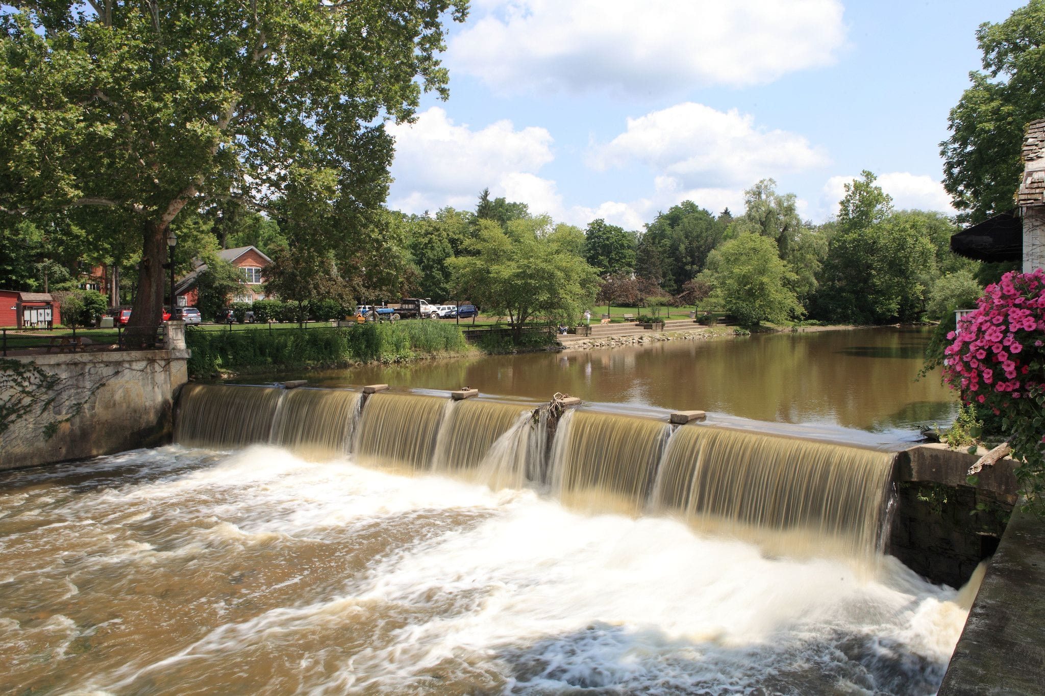 The waterfall at Chagrin Falls, Ohio, tumbling over a broad stone ledge beside the village's red-brick downtown buildings