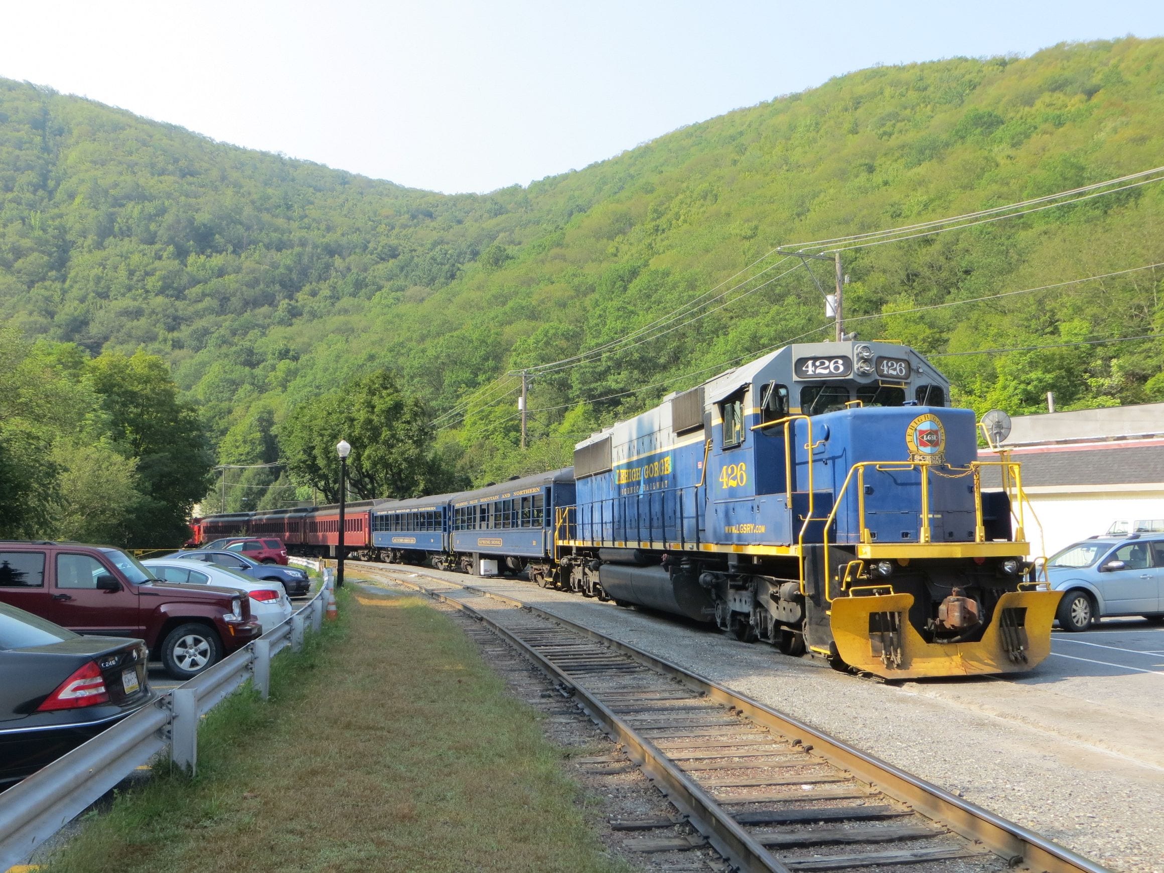 A Lehigh Gorge scenic railway train beside the wooded hills at Jim Thorpe, Pennsylvania