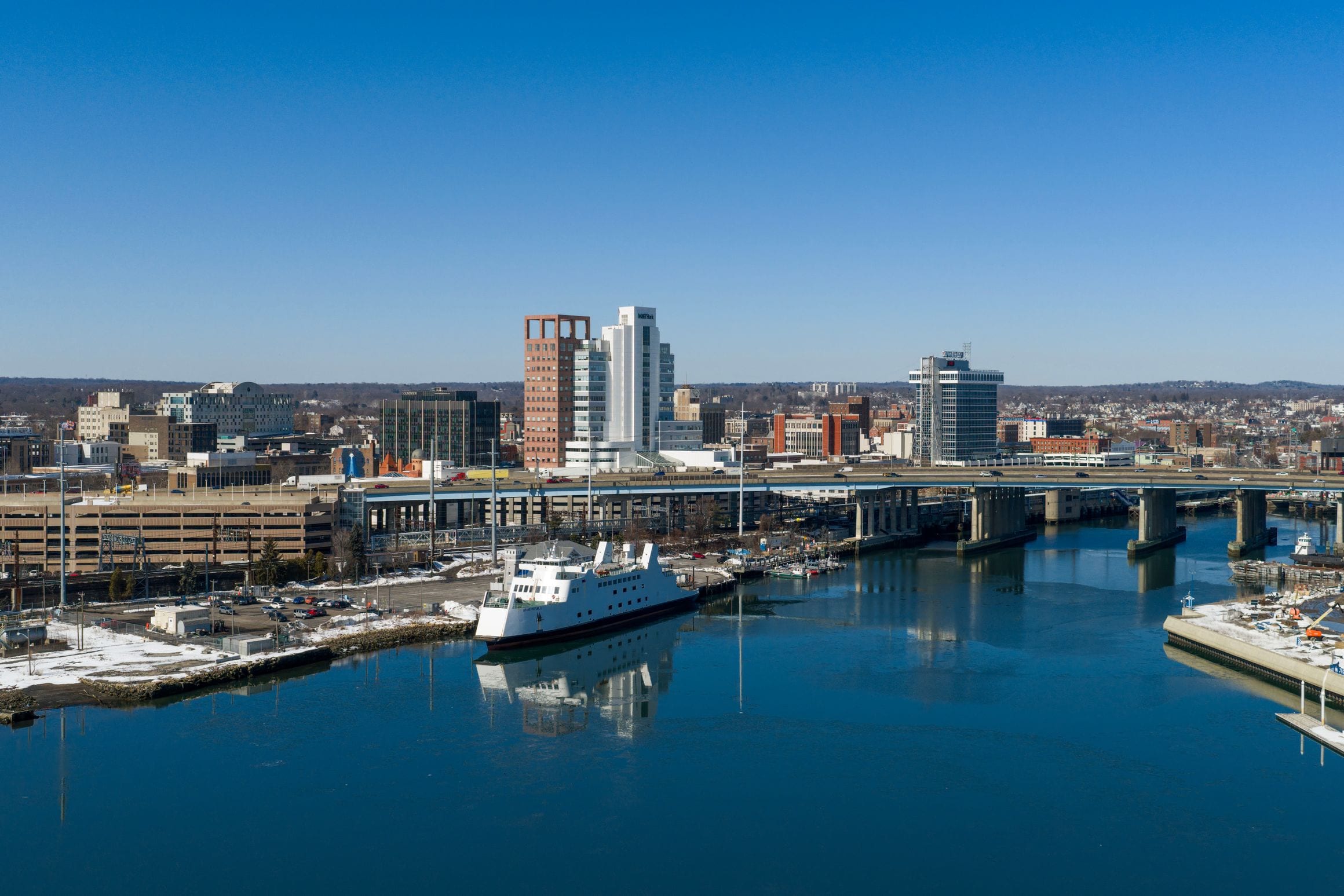 Downtown Bridgeport, Connecticut, with the city skyline, harbor and a ferry on the waterfront