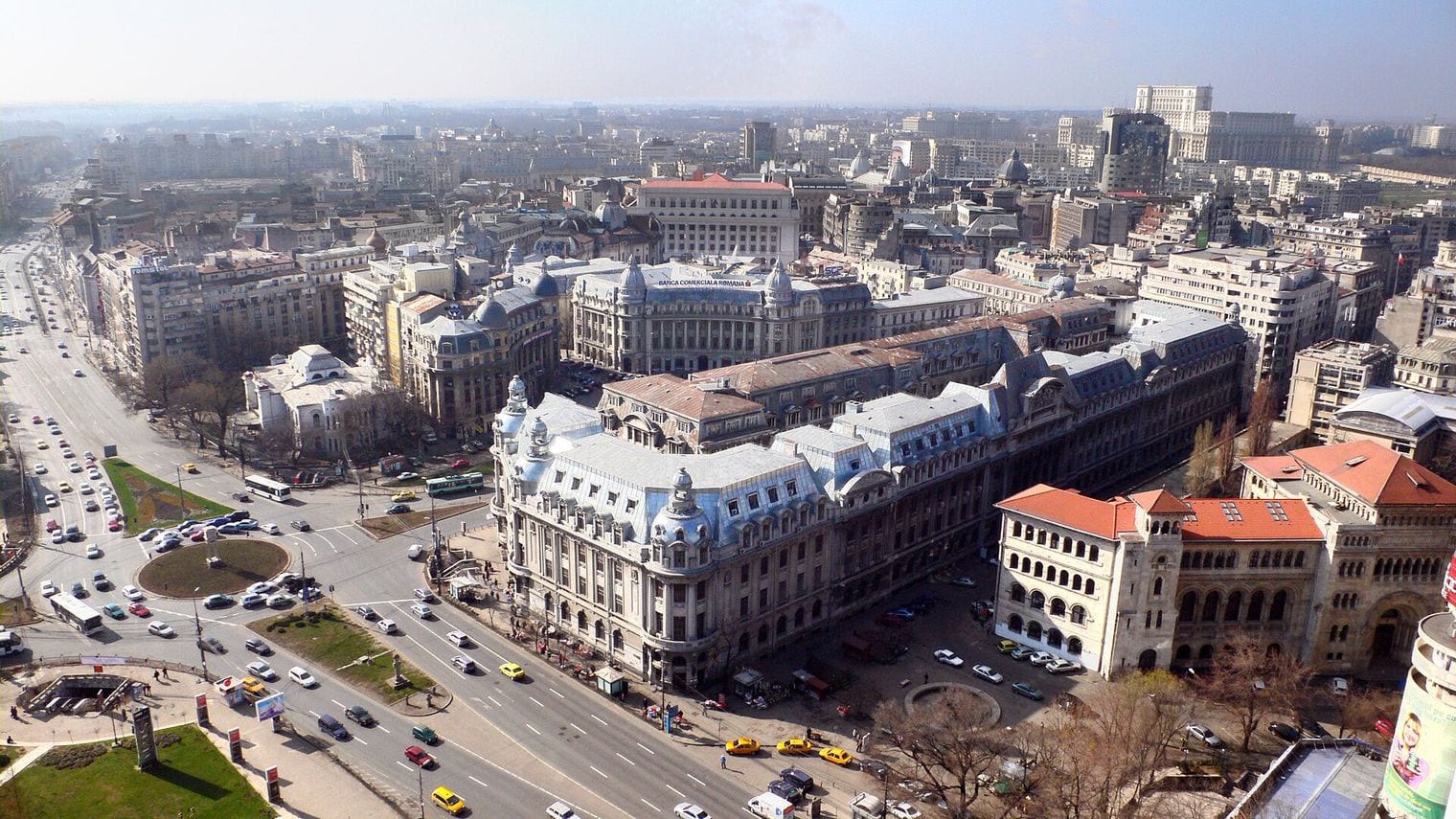 The domed neoclassical Romanian Athenaeum in Bucharest, its columned portico rising above formal flowerbeds