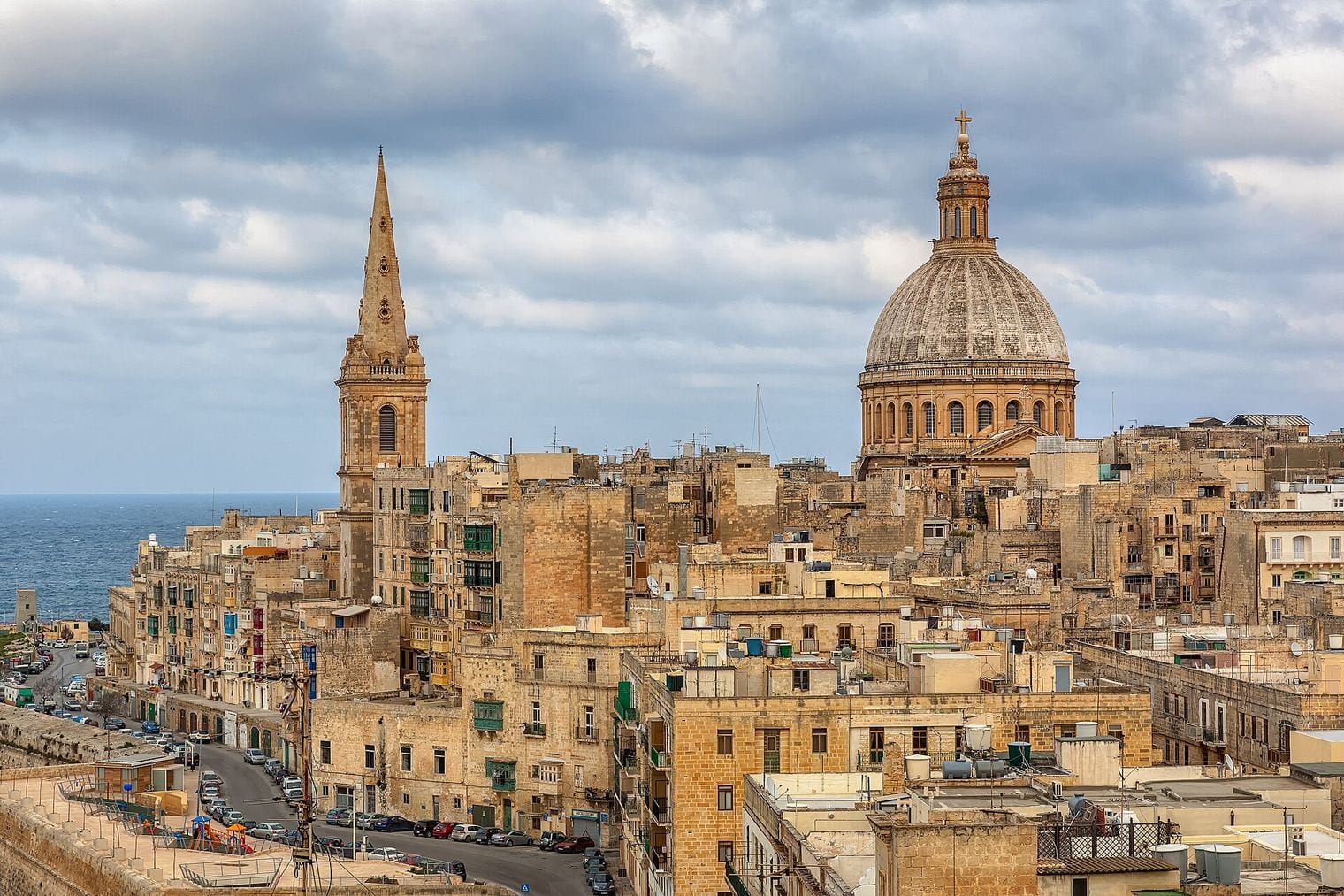 The Valletta skyline from St Andrew's Bastion, with the spire of St Paul's Pro-Cathedral and the dome of the Basilica of Our Lady of Mount Carmel above honey-coloured rooftops