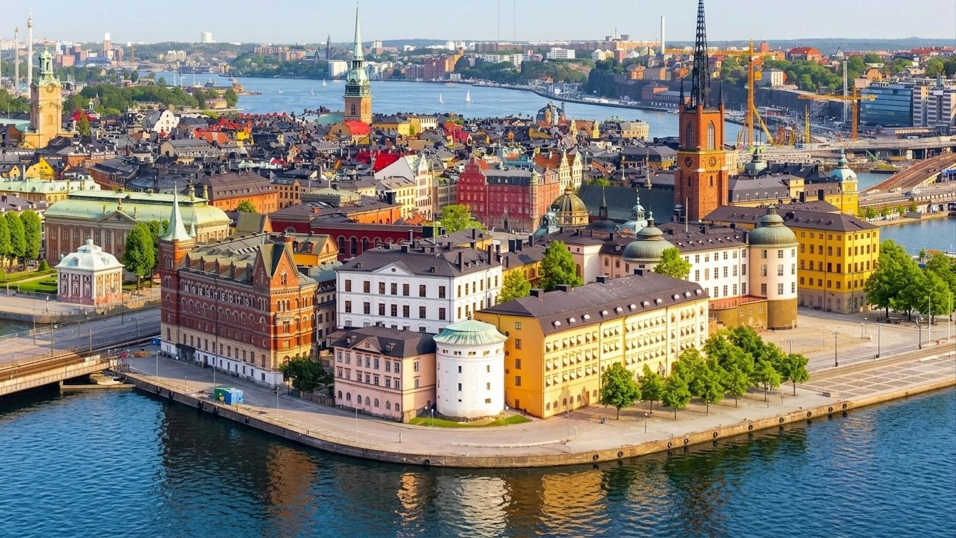 Aerial view of Riddarholmen and Gamla stan in Stockholm, the rust-red spire of Riddarholmen Church rising above waterfront rooftops