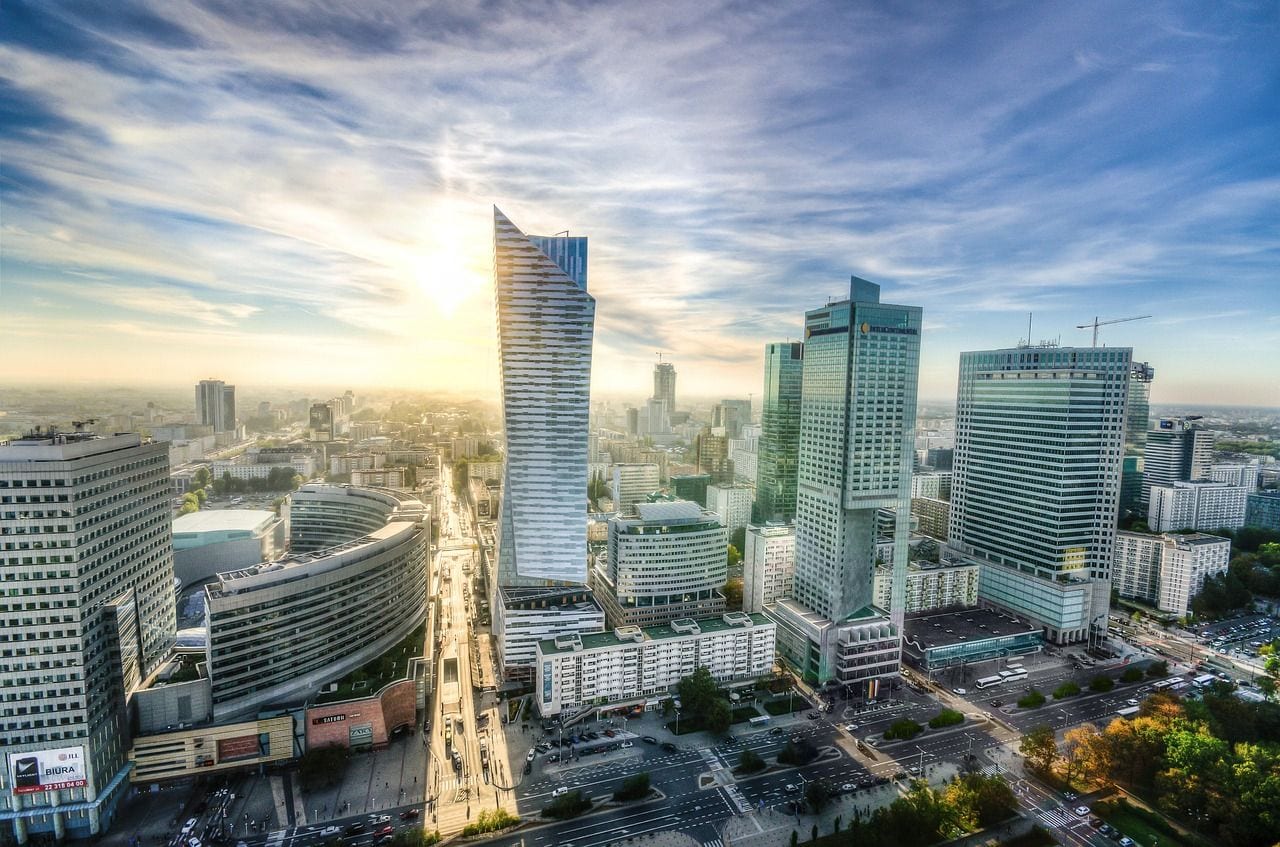 Warsaw's modern skyline at sunset, the twisted glass Złota 44 tower rising above the city centre